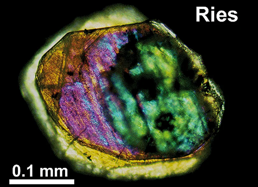 Impact diamonds from the Ries Im Dünnschliff schimmert ein etwa 0.3 mm großer Riesdiamat orange, lila und grün.
