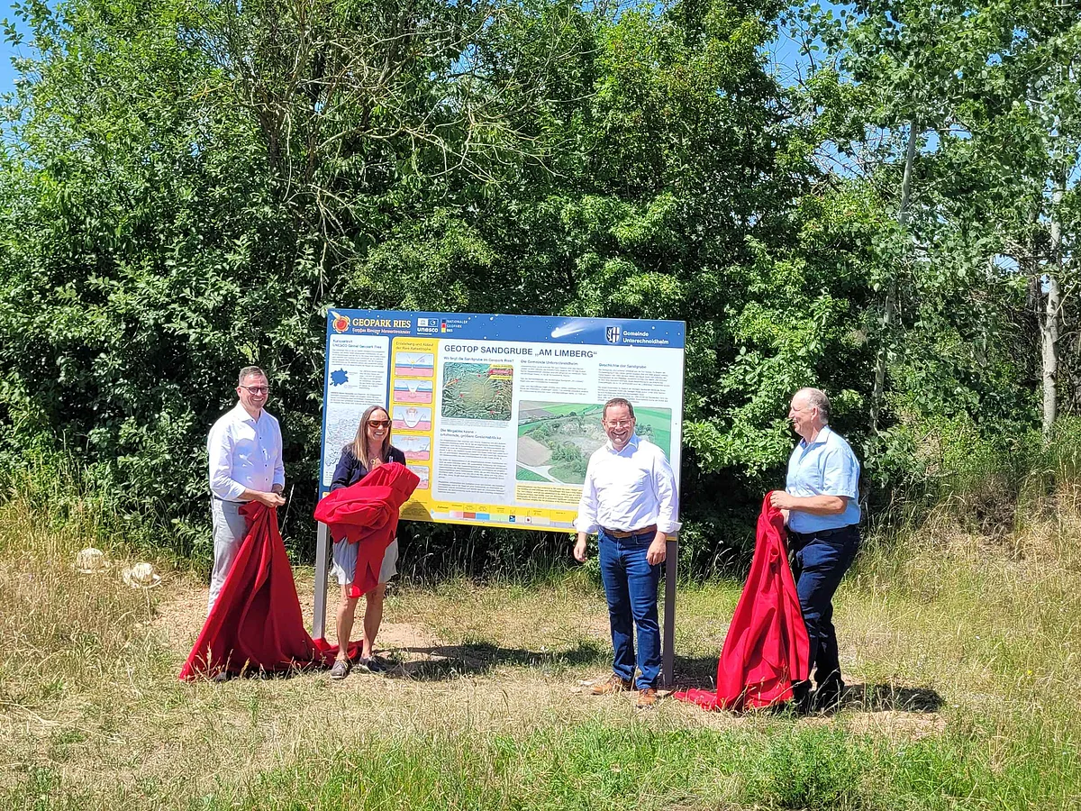 Landrat Joachim Bläse, die Vorsitzende das Geopark Ries eV., Bürgermeister Johannes Joas und Ortsvorsteher Stefan Joas enthüllen die Infotafel.